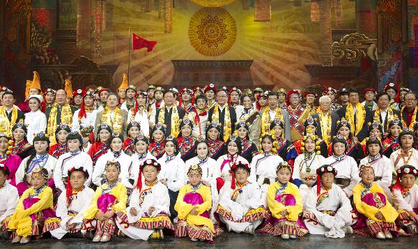 China's top legislator Wu Bangguo poses with others after watching a song and dance drama that praises the relief and reconstruction efforts after a deadly earthquake shook Yushu Tibetan Autonomous Prefecture in northwest China's Qinghai Province a year ago in Beijing, capital of China, April 15, 2011. [Photo/Xinhua]