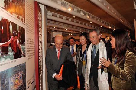 Visitors look at the photos during the Week of the 2010 China Tibetan Culture in Madrid, Spain, Nov. 15, 2010.