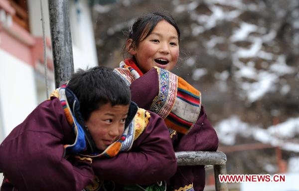 Two students at Deqin County Chartiy Tibetan School frolic outside in Deqen County, Diqing Tibetan Autonomous Prefecture, southwest China's Yunnan Province, March 10, 2011.