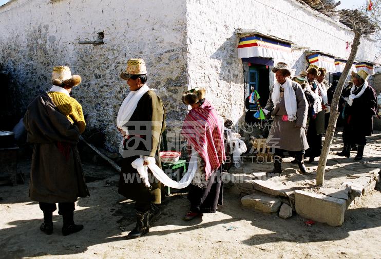A Tibetan bride is walking out of her house