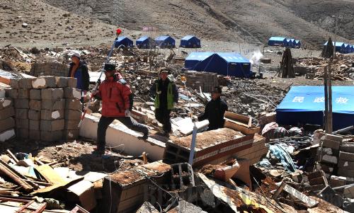 Staff with the Qinghai Provincial Bureau of Surveying and Mapping survey circumstances in Trangu Village on April 27 to prepare for its reconstruction