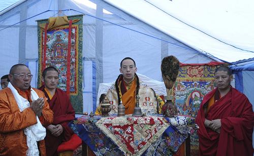 The 11th Panchen Lama (2nd R) hosts prayer ritual in a tent to guide the souls of those who died through suffering to heaven