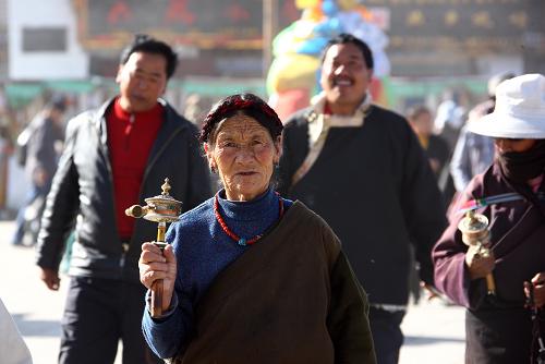 A Tibetan elderly person takes a ritual walk in Barkor Street of Lhasa