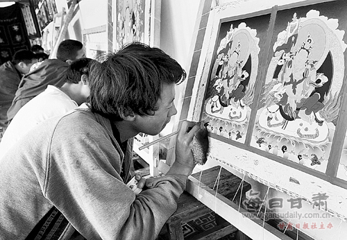 A Thangka painting apprentice is working on a piece of Thangka in Labrang Mani Thangka Exhibition Center of Xiahe country, northwest China's Gansu province.