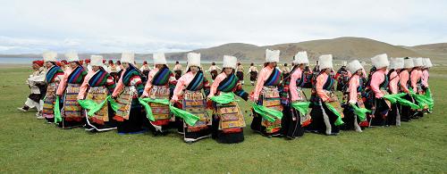 Tibetan herdsmen are performing Shekhen, a traditional Tibetan dance