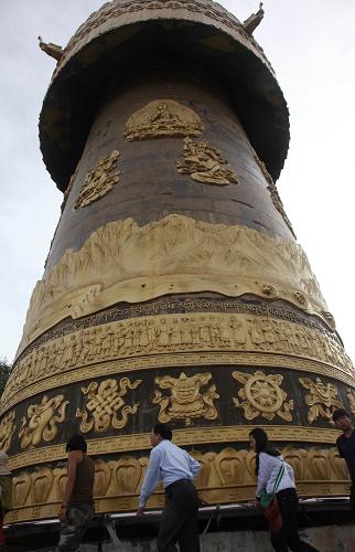 Tourists take ritual walks around the gigantic prayer wheel in Shangri-la County, Deqen Prefecture of southwest China’s Yunnan Province, July 22.
