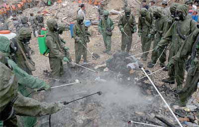 Soldiers disinfect an area Wednesday, days after a massive landslide swept through Zhouqu County, Gansu Province.