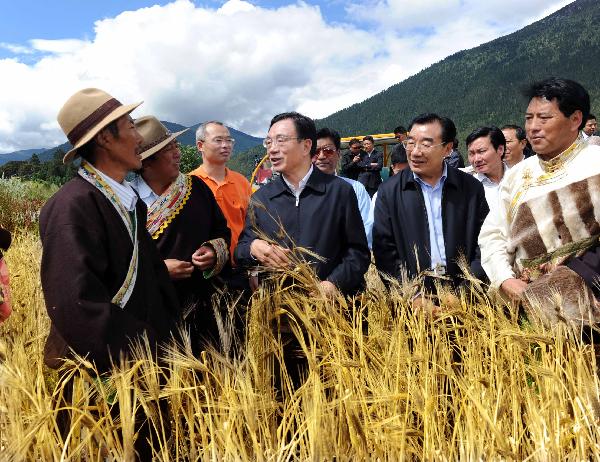 He Guoqiang (C Front), a member of the Standing Committee of the Political Bureau of the Central Committee of the Communist Party of China (CPC) and chief of the CPC Central Commission for Discipline Inspection, talks with local farmers of the Tibetan ethnic group at Zhaxigang Village in Nyingchi County