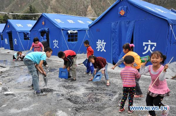 Children clean up the ground at the temporary shelter in mudslides-hit Zhouqu County, northwest China's Gansu Province, Sept. 22, 2010. Local residents celebrated the first Mid-Autumn Festival after the mudslides at the temporary shelter on Wednesday.