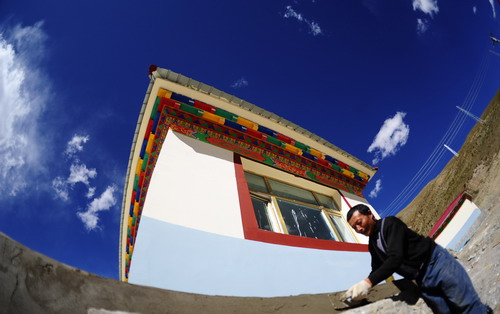 A mason puts the finishing touches to a newly-built house in Yushu county, Northwest China's Qinghai Province, on Thursday Oct 7, 2010. A 7.1-magnitude quake jolted the county in April, leaving more than 2,200 people dead and thousands of homes leveled. The construction of the new houses started on May 4 and is expected to be completed on Sunday.