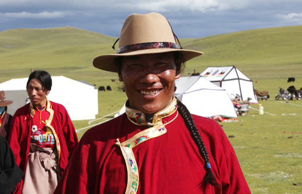 A Tibetan man smiles on the Qinghai-Tibet Plateau.