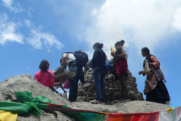 Buddhist follower takes ritual walks around a incense burning place  on Qingpu Mountain, the holy cultivation place near Samye Monastery in Lhoka, Tibet Autonomous Region. [Photo/China Tibet Online]