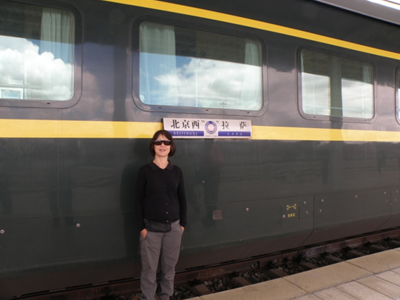 Kerry Song poses in front of a Beijing-Lhasa train in undated photo.