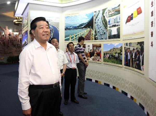 Jia Qinglin (front), chairman of the National Committee of the Chinese People's Political Consultative Conference, visits the exhibition marking the 60th anniversary of the peaceful liberation of Tibet in Beijing, capital of China, July 8, 2011. [Photo/Xinhua]