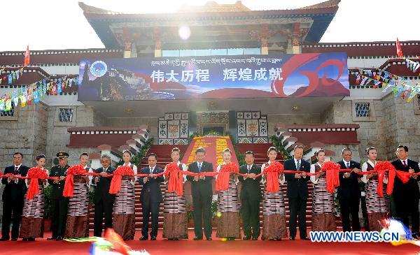 Chinese Vice President Xi Jinping (C) attends the ribbon-cutting ceremony for the exhibition of achievements made in the 60 years since Tibet's peaceful liberation, in Lhasa, capital of southwest China's Tibet Autonomous Region, July 18, 2011. [Photo/Xinhua]