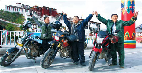 Motorcyclists (L-R) Tang Yiping, Wu Gang and Zhu Xiaofeng meet at the Potala Square in Lhasa on Sunday after dozens of days of travel from Zhejiang, Hebei and Heilongjiang provinces. (Photo China Daily)