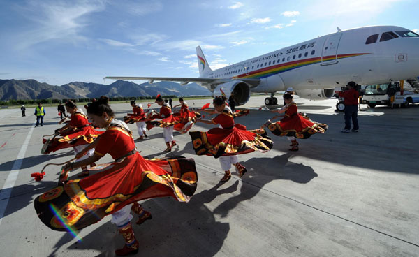 Dancers perform Tibetan songs and dances during a ceremony to mark the maiden flight of a plane of the newly-established Tibet Airlines at Lhasa Gonggar Airport in Lhasa, the capital of Southwest China's Tibet autonomous region, July 26, 2011. The airline is the first Lhasa-based airline to set up operations there. The maiden flight will fly to Tibet's Ngari prefecture. [Photo/Xinhua]