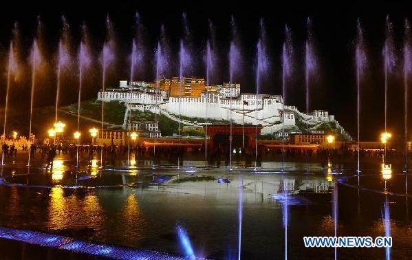 Visitors stroll at the Potala Palace Square in Lhasa