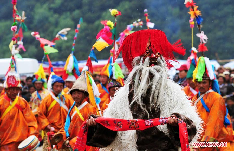 A folk artist wearing a traditional mask performs during the opening ceremony of 7th Basum Folk Cultural Festival