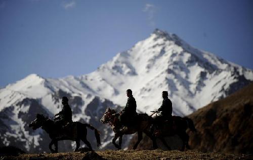 File photo taken on May 10, 2011 shows a patrol troop is on duty to protect wild animals in NgariPrefecture of southwest China's Tibet Autonomous Region. As the place closest to heaven, the Qinghai-Tibetan Plateau, also known as the roof of the world, is a paradise to such wild animals as Tibetan antelopes, wild yaks and wild Tibetan donkeys.