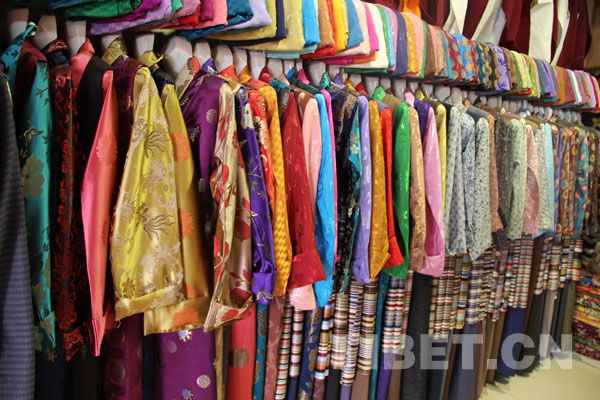 Beautiful Tibetan costumes are on sale in the shops along the Barkhor Street, which is located in downtown Lhasa, capital of Tibet Autonomous Region on Dec. 1. The Barkhor Street has small streets and alleys extending in all directions and is unique with ethnic features and stunning diversity. [Photo/China Tibet Online]