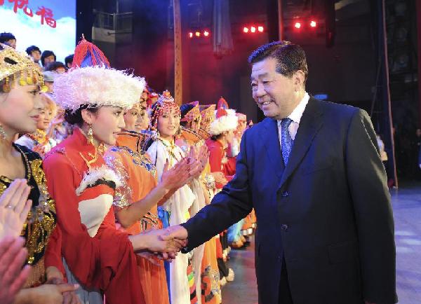 Jia Qinglin (1st R), a member of the Standing Committee of the Communist Party of China (CPC) Central Committee and chairman of the Chinese People's Political Consultative Conference (CPPCC) National Committee, shakes hands with artists from the Tibetan Autonomous Prefecture of Gannan, northwest China's Gansu Province, after watching a performance in Beijing, capital of China, Jan. 5, 2012. Jia Qinglin watched a performance given by the artists from Gannan on Thursday. [Photo by Wang Ye/Xinhua]