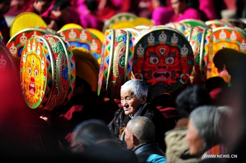 Tibetans watch the dance performance in the Labrang Monastery in Xiahe County, northwest China's Gansu Province, Feb. 5, 2012. Labrang Monastery held a Buddhist dance performance on Sunday, the 14th day of the first month in the traditional lunar calendar. The important event is held to pray for an auspicious new year. Labrang Monastery, built in 1709, is home to more than 1,000 lamas and is one of six prestigious monasteries of the Gelugpa, also known as the Yellow Hat Sect, of Tibetan Buddhism. [Xinhua/Zhang Meng]