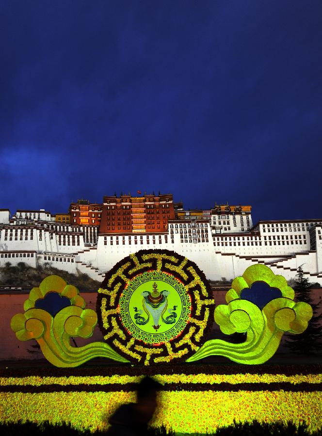 A sculpture with a picture of a trumpet shell, which represents auspiciousness, is seen on the Potala Palace Square in Lhasa, southwest China's Tibet Autonomous Region, Feb. 19, 2012. Festive decorations are put on around the Potala Palace as Losar, or the Tibetan New Year, approaches