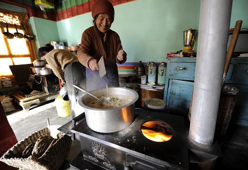 A villager of Dagze County in Lhasa, capital of Tibet, is boiling Guthuk, a kind of dough soup, to embrace the Tibetan New Year which falls on Feb. 22, 2012. [Photo/Xinhua]