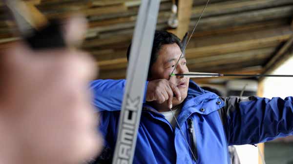 A group of youths take part in a whistling archery race at a family hotel in Menling County of Nyingchi Prefecture in southeast Tibet Autonomous Region on March 23, 2012. [Photo/Xinhua]