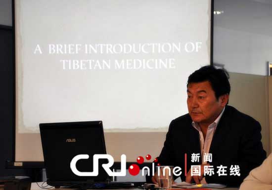 Tsewang Demba, director of the out-patient department of Tibet Tibetan Medicine Hospital, introduces Tibetan medicine in Berlin, capital of Germany on June 25, 2012. [Photo/CRI Online]