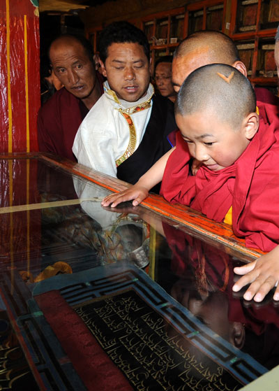 Dezhub Jamyang Sherab Palden (right) reads sutras
