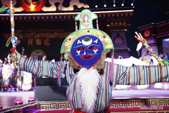 An artist wearing Tibetan costume performs at the opening ceremony of Shoton Festival