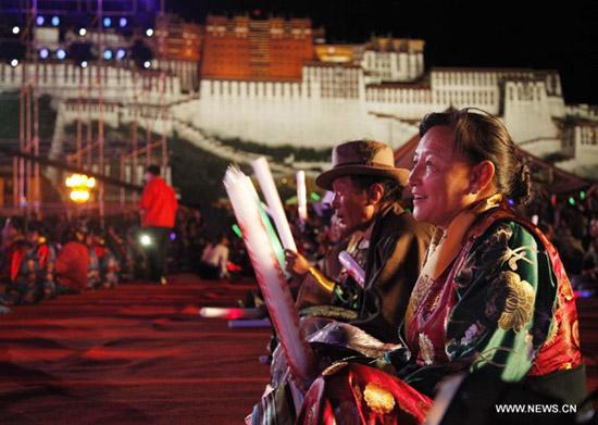 Tibetan people enjoy the performance at the opening ceremony of Shoton Festival in Lhasa,