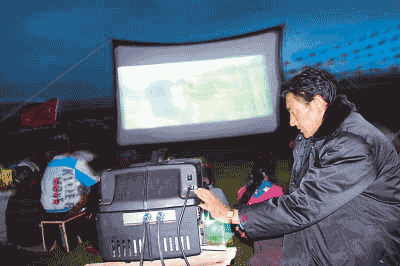 Projectionist Tsering Paljor is showing the movie for villagers.
