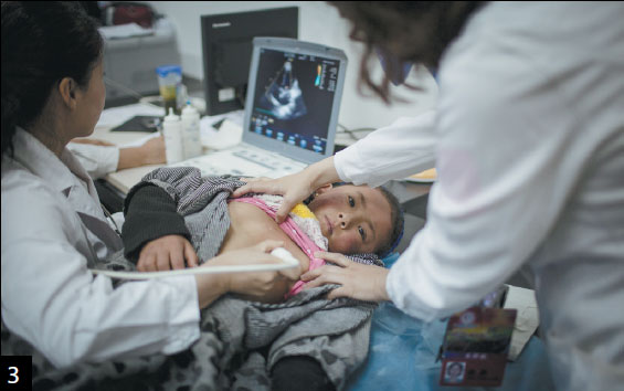 Doctors examine a Tibetan boy, 7, who has congenital heart disease. The low-oxygen environment is conducive to developing the disease.