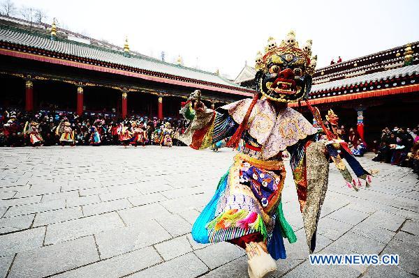 A lama wearing a ritual mask and costume performs a ghost dance during a religious rite at the Taer Monastery in Xining, northwest China's Qinghai Province, Feb. 16, 2011. The ghost dance is performed across Tibetan regions to ward off disasters and bring luck and fortune.