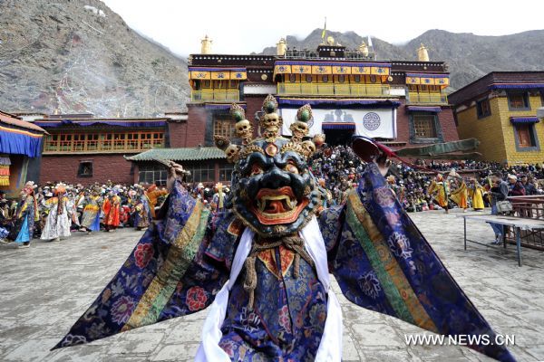 Lamas dance to banish evil spirits during the Holy Dance Festival in Curpu Temple, 70 kilometers away from Lhasa, capital of southwest China's Tibet Autonomous Region, June 11, 2011. The annual Holy Dance Festival, a traditional Buddhist rite to banish evil spirits, was held in Curpu Temple on Saturday, attracting tens of thousands of Buddhists. [Photo/Xinhua/Purbu Zhaxi]